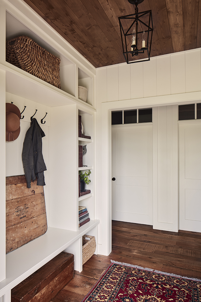 closet space with rug on wood floor and white shelving