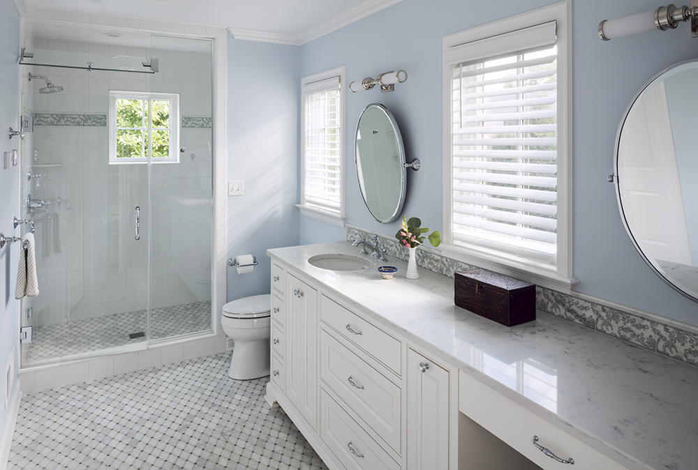 large, white bathroom with light blue walls