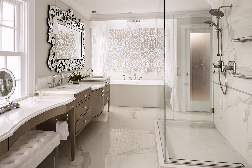 all white bathroom with marble floor, glass standing shower, tub, vanity, and sitting area with long bench